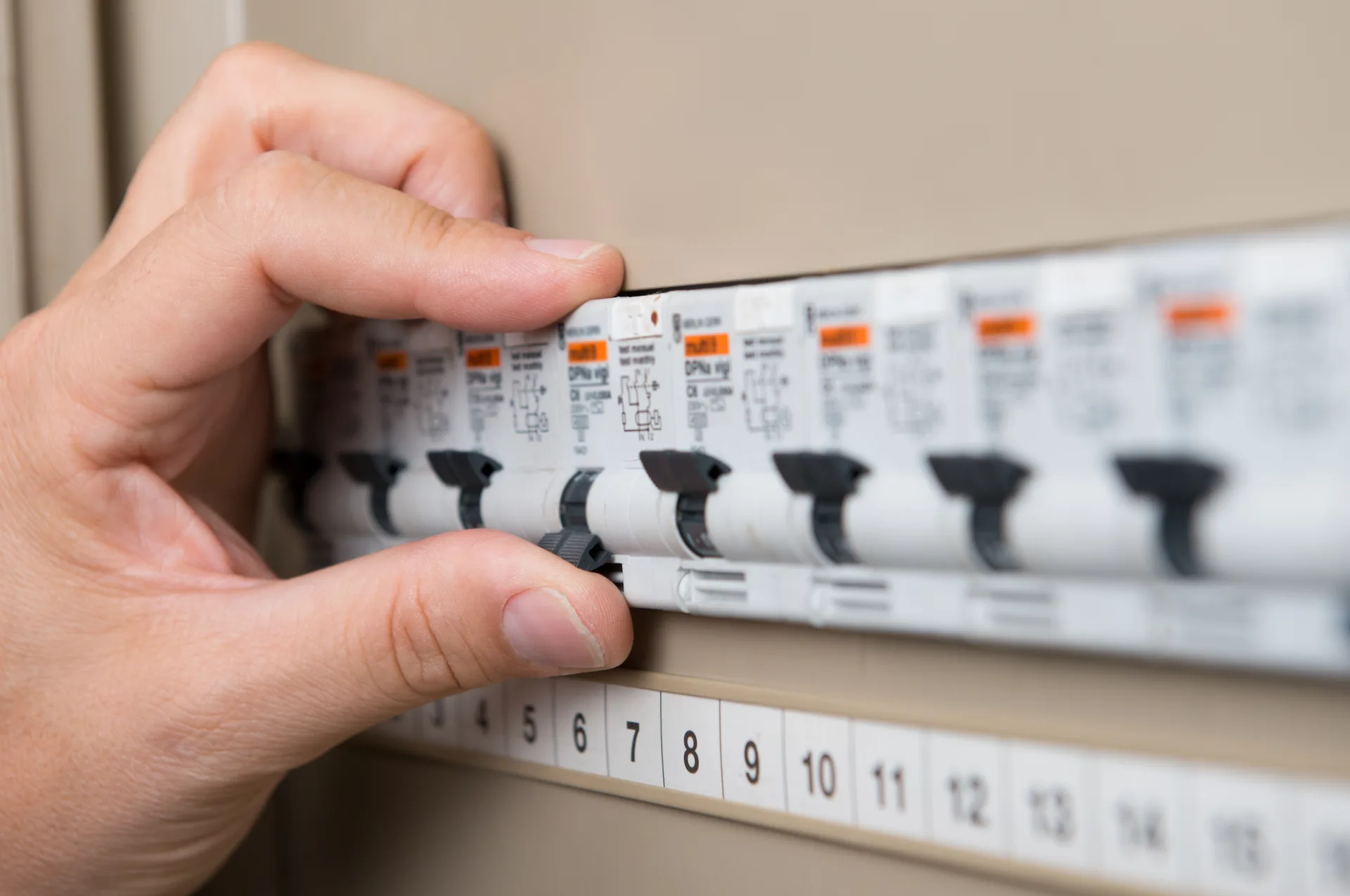 Close-up of circuit breakers being tested in a switchboard